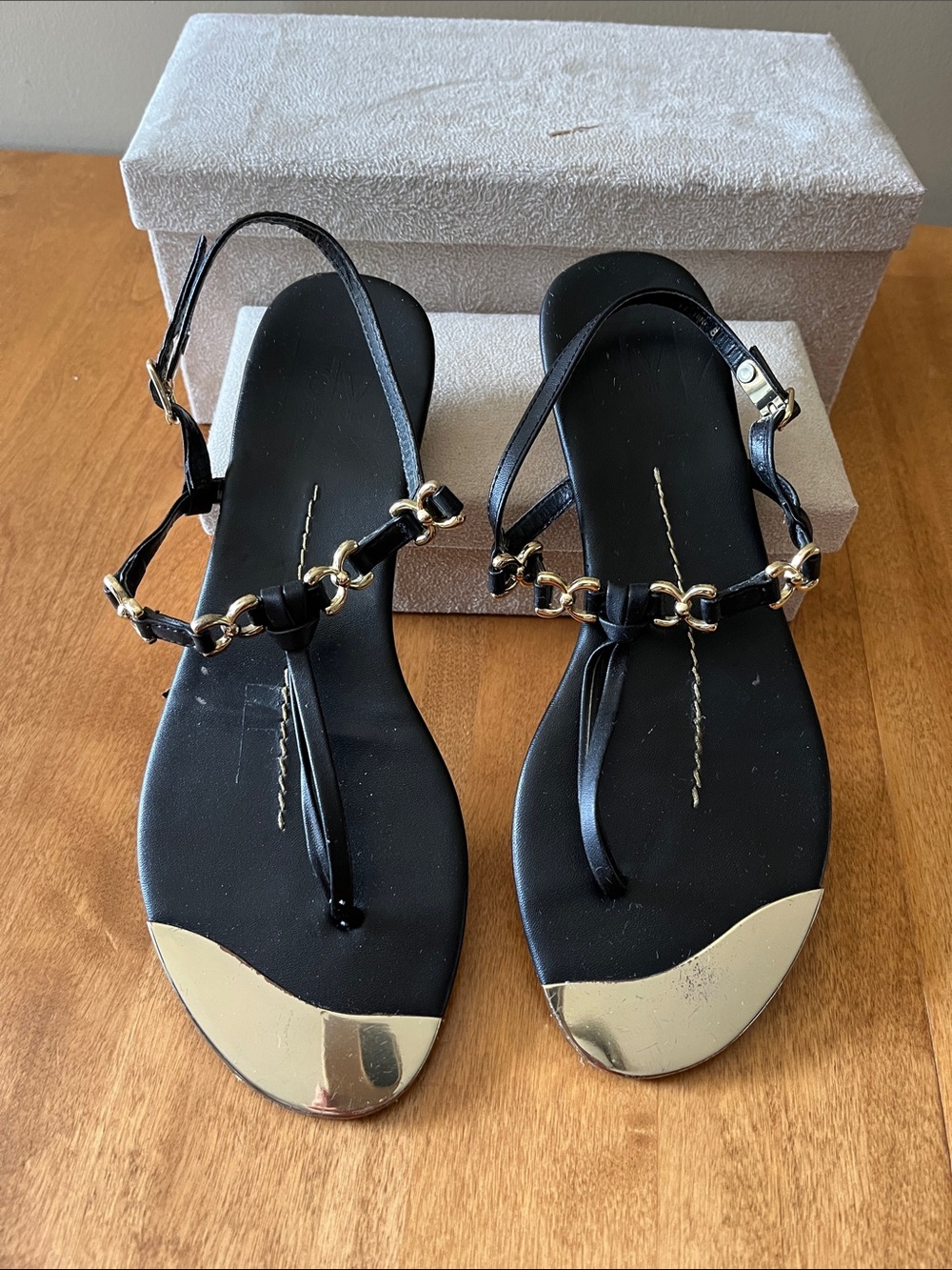 Woman’s Black Leather Strap Sandal with Gold Accent